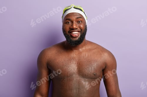 Preview: Joyful black man has strong body, shows wet torso, enjoys recreation time and swimming, prepares for
