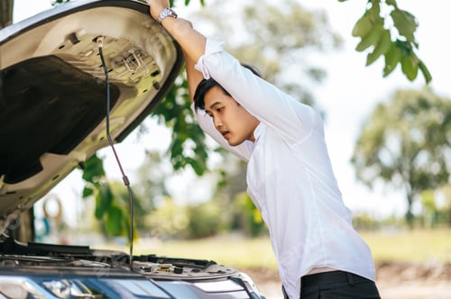 Preview: Man opens the hood of a car to fix the car.