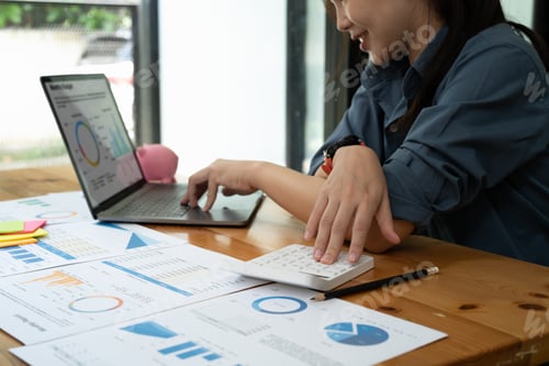 Preview: businesswoman working on desk office with using a calculator to calculate the numbers, finance