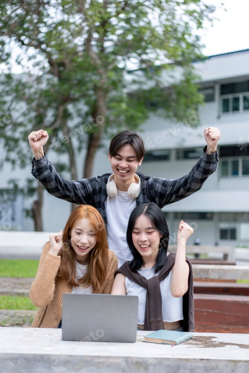 Preview: Three young people are celebrating with their hands in the air