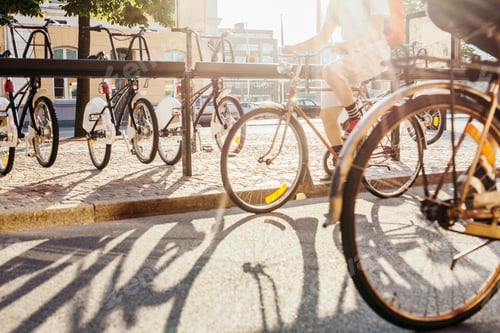 Preview: Low section of men cycling on city street