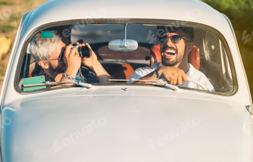 Preview: Men with camera traveling in car