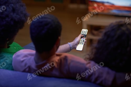 Preview: High angle of man holding remote and watching TV
