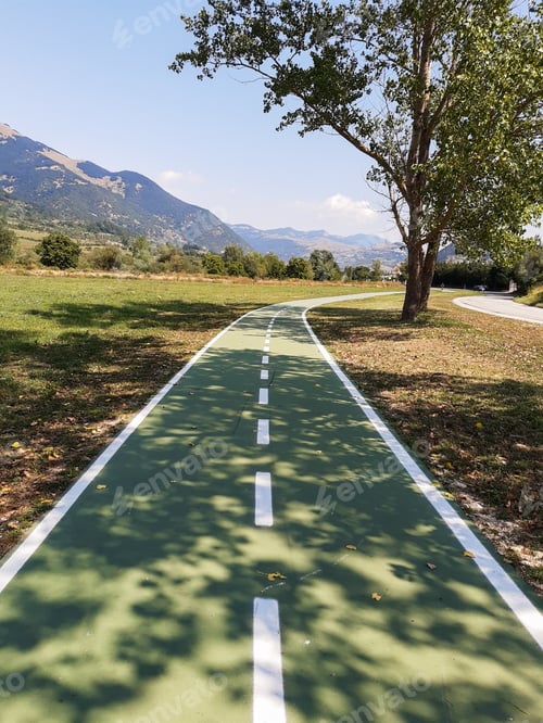 Preview: Green cycle lane for bikes in a mountain town in Italy