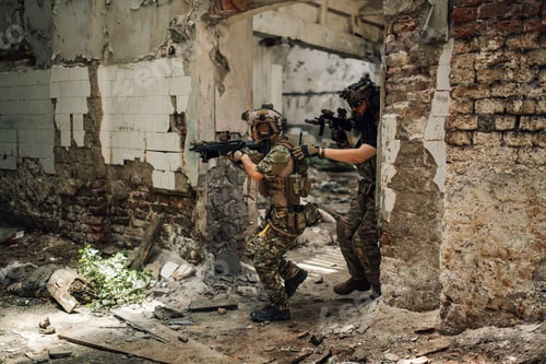 Preview: Group of air soft players in action going in battle in ruined building