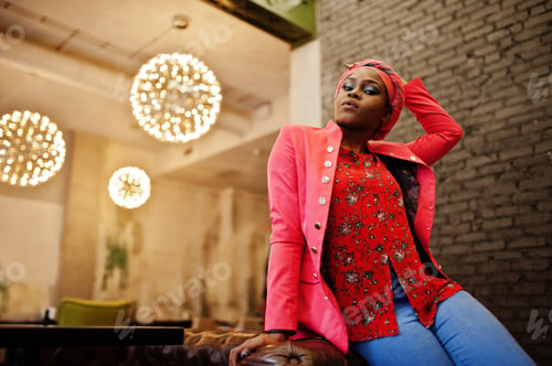 Preview: Stylish african woman in red shirt and hat