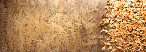 Preview: Wood shaving on table background. Wooden shavings at old plank board texture