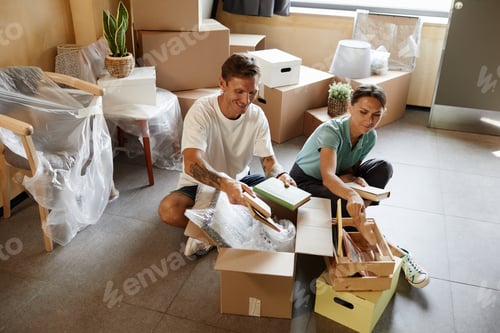 Preview: Couple Unpacking Boxes in New Home