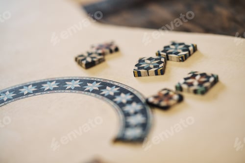 Preview: Wooden blocks with ornaments of taracea, placed on Spanish flamenco guitar in luthier workshop.