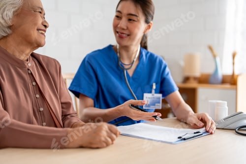 Preview: Asian young caregiver nurse examine senior woman patient at home.