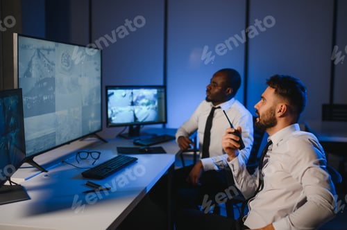 Preview: Two male security guards looking at computer screen while one of them explaining detail of video