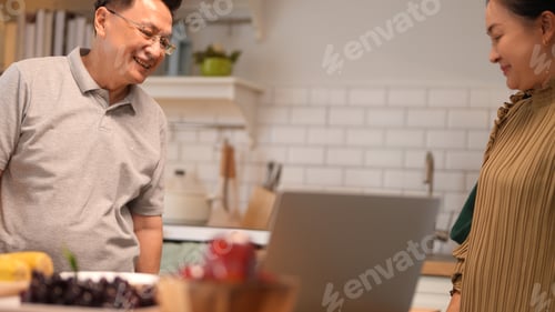Preview: Happy family, grandmother, grandfather and grandson have a good time together in the kitchen.