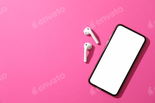 Preview: Phone with empty screen and headphones on pink background, top view