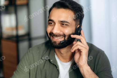 Preview: Support service concept. Close-up of friendly pleasant attractive Indian or Arabian man with headset