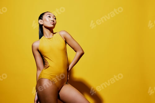 Preview: Woman smile studio summer person beauty swimsuit fashion black yellow portrait trendy surprised