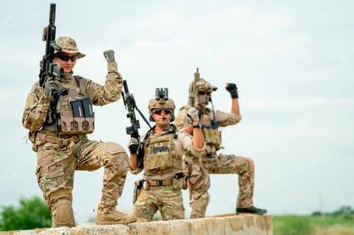 Preview: Military or soldier team with gun stay on concrete wall and also raise one's hand for action success