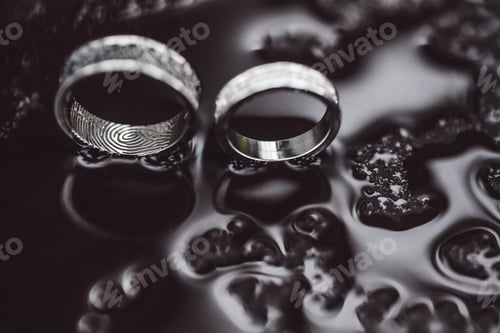 Preview: Wedding rings on water surface texture
