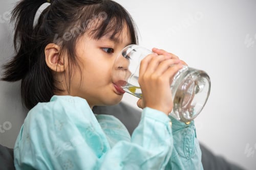 Preview: Girl drinks water from a glass