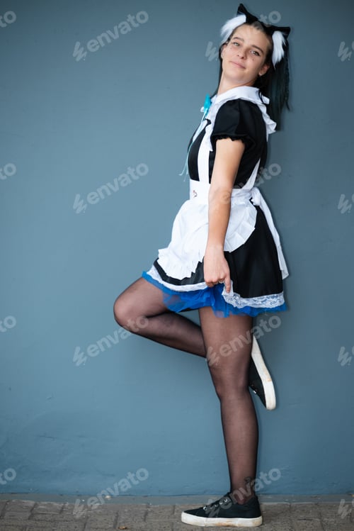 Preview: Caucasian female cosplayer with cat ears in a Japanese maid outfit
