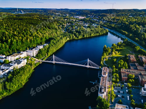 Preview: Aerial view of blue lake with cable-stayed bridge and green summer town in Finland.