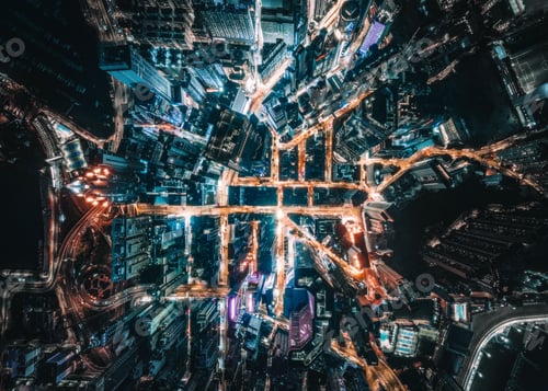 Preview: Aerial shot of busy highways surrounded by lights and modern skyscrapers at night in Hong Kong