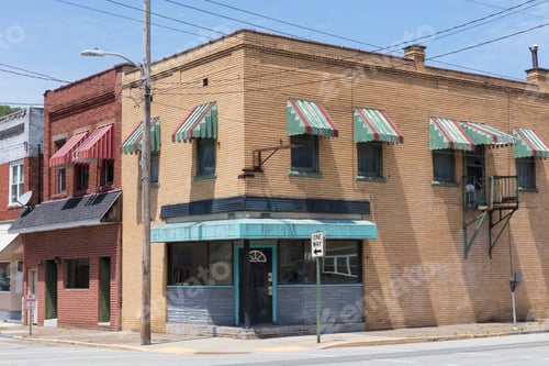 Preview: Apartment buildings and storefronts along an empty street.