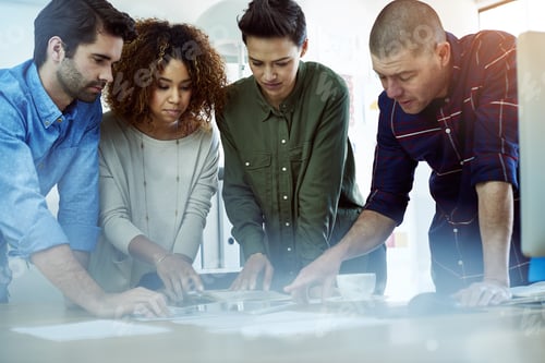Preview: Cropped shot of a group of coworkers discussing something on a tablet