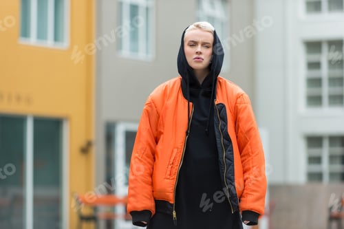 Preview: Young Woman in Black and Orange Jacket Posing