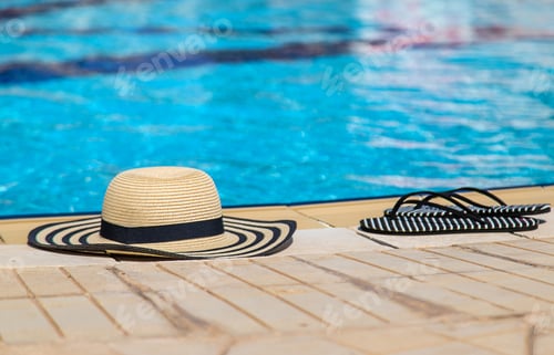 Preview: Hat and beach flip-flops. Selective focus.