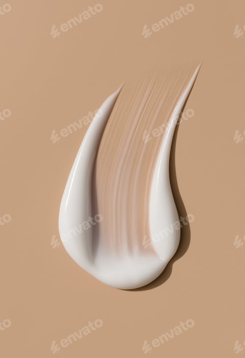 Preview: creamy smear of white cosmetic texture close up on beige background skin care concept