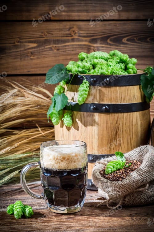 Preview: Dark beer straight from the barrel on old wooden table