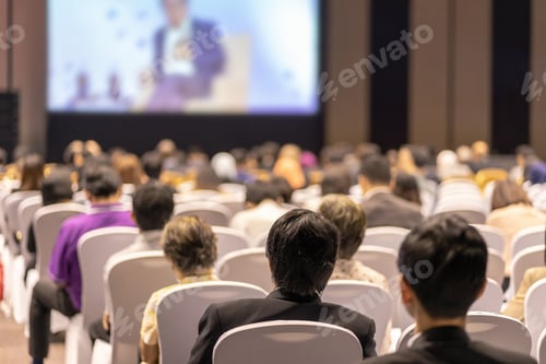 Preview: Rear view of Audience listening Speakers on the stage in the conference hall or seminar meeting