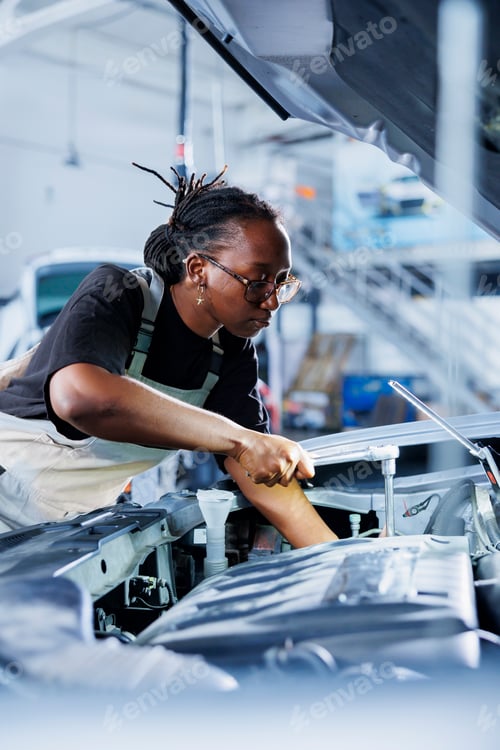 Preview: Garage worker inspects car engine