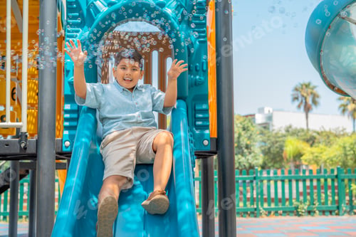 Preview: Boy sliding down a slide with a happy face
