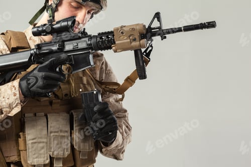 Preview: Soldier prepares weapon in training environment with attention to detail and focus on safety