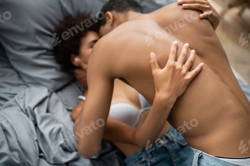 Preview: high angle view of young and passionate african american couple making love on blurred background