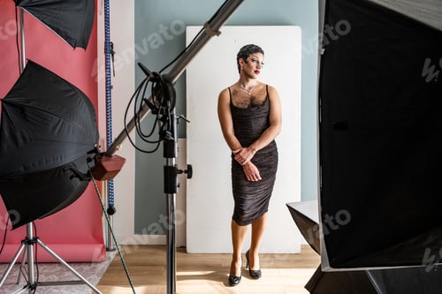 Preview: Stunning Drag Queen Posing Elegantly Amidst Professional Studio Lighting Setup