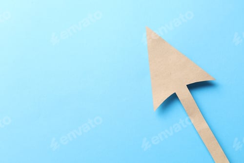 Preview: One kraft paper arrow on light blue background, top view. Space for text