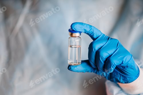 Preview: Doctor, nurse, scientist hand hold COVID-19 vaccine for the disease Coronavirus. Use for preventio