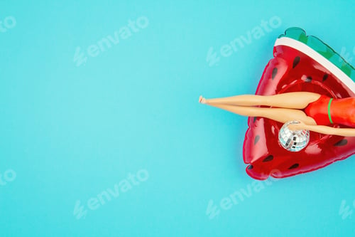 Preview: Doll in the swimming suit with the inflatable watermelon. Beach, swimming pool party concept