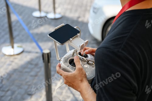 Preview: Professional videographer holding remote control for drone