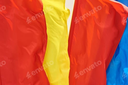 Preview: colored flags flying in the wind, closeup