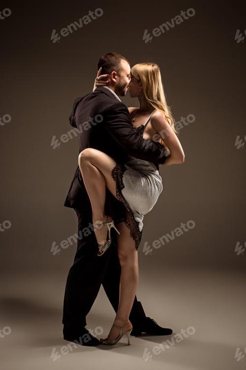 Preview: A Man And A Woman Dancing Argentinian Tango On Gray Studio Background