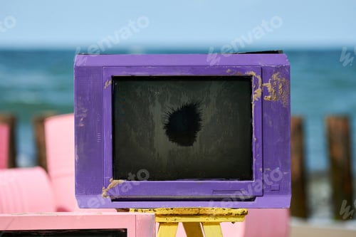 Preview: Old purple television with black broken screen on table, creative violet vintage TV-set. 80s, 90s