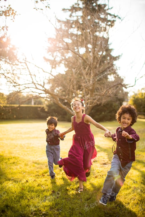 Preview: Three kids holding hands and running in the park