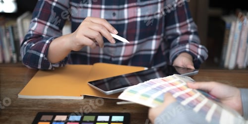 Preview: Two artists working on tablet, colour paper tone on workspace at the office