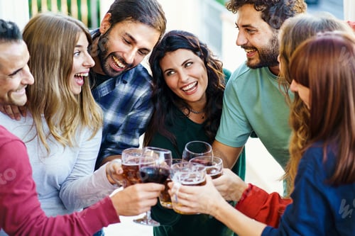 Preview: Group of happy friends cheering together toasting beer and wine standing on the balcony -