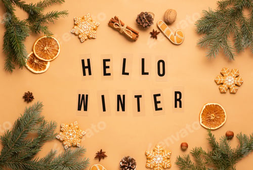 Preview: Christmas background, gingerbread New Year's toys fir branches, phrase Hello winter brown background