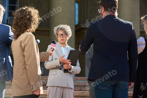 Preview: Middle Aged Caucasian Woman Giving Interview to Journalists Outdoors