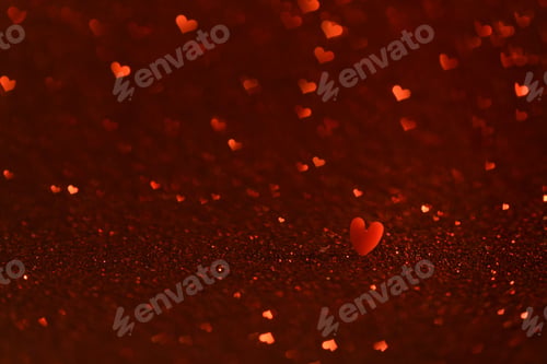 Preview: Red small heart on glittering background with hearts shaped bokeh.